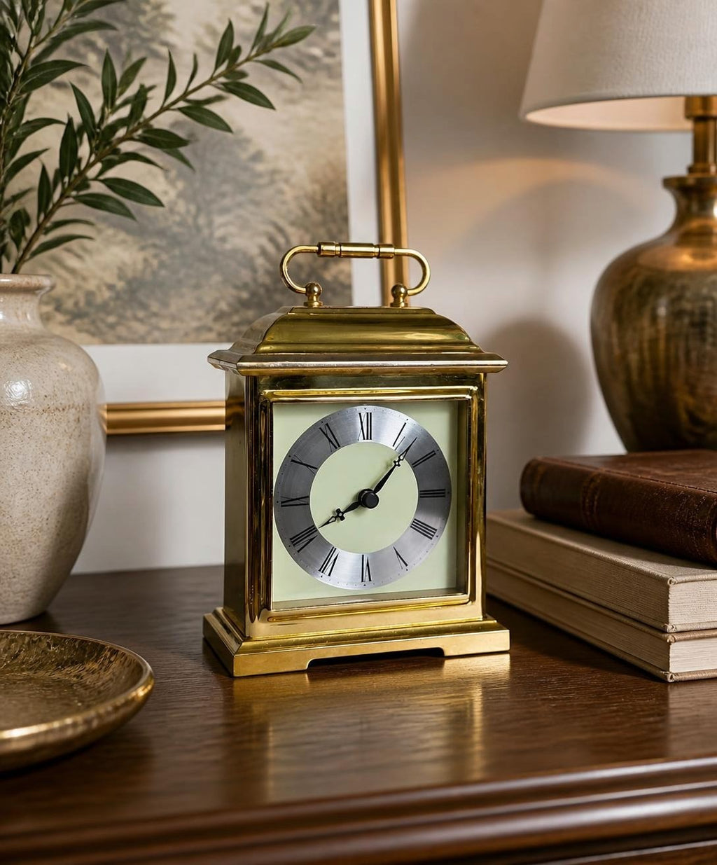Oddly Darling Vintage Bulova carriage mantel clock in polished gold-tone with a cream face and Roman numerals.