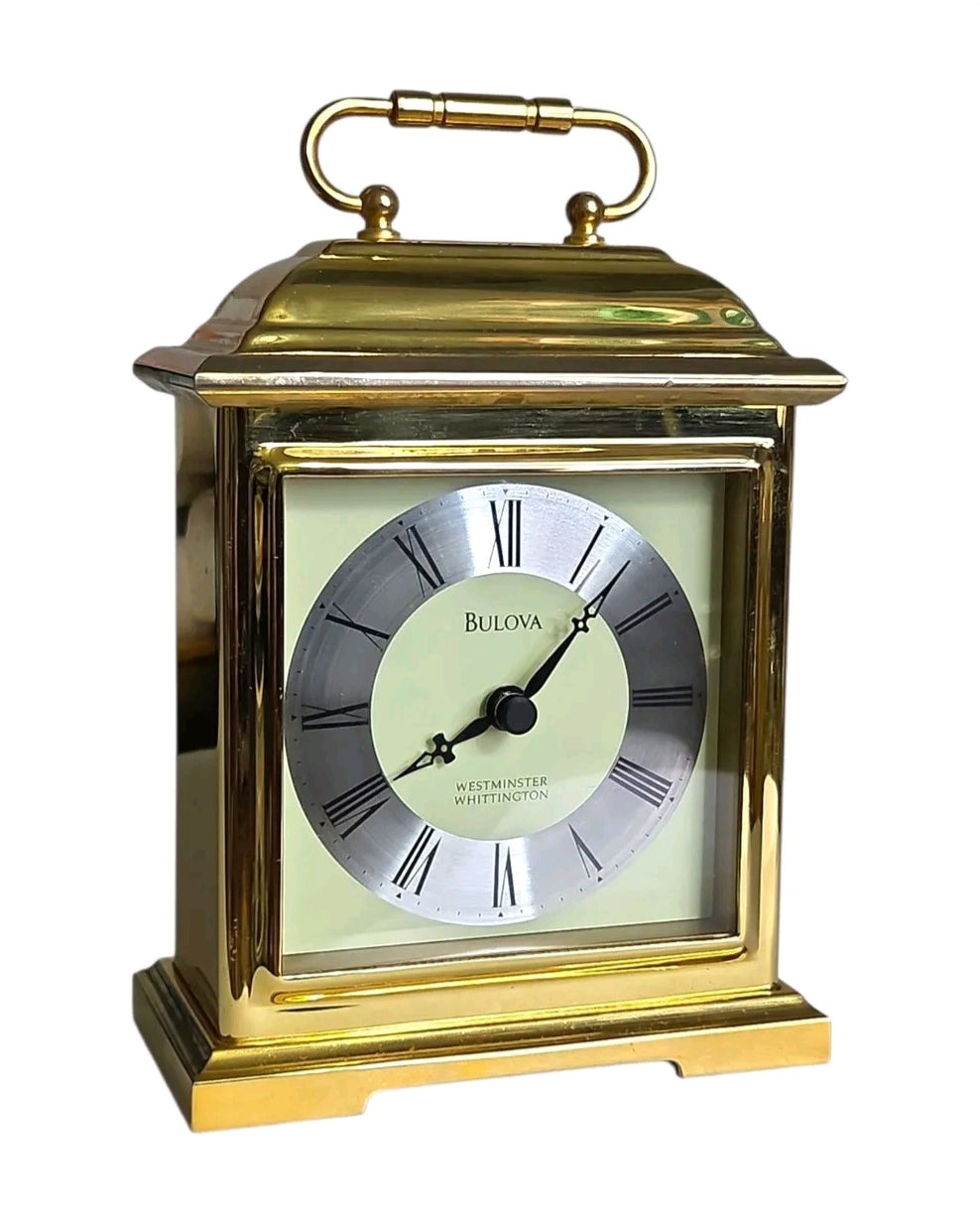 Oddly Darling Vintage Bulova carriage mantel clock in polished gold-tone with a cream face and Roman numerals.