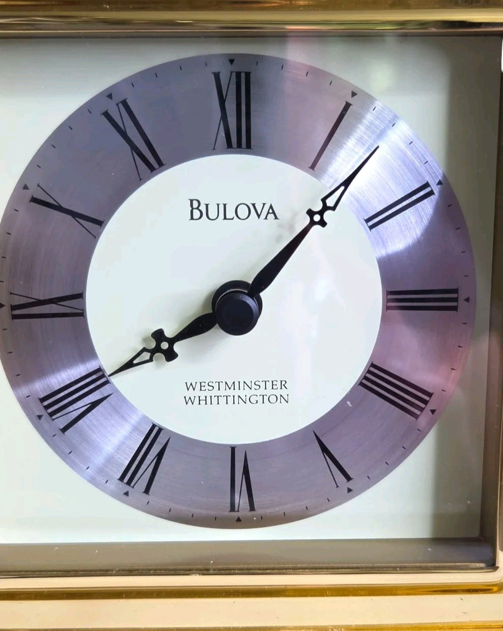 Oddly Darling Vintage Bulova carriage mantel clock featuring a cream face, silver chapter ring, and Roman numerals.