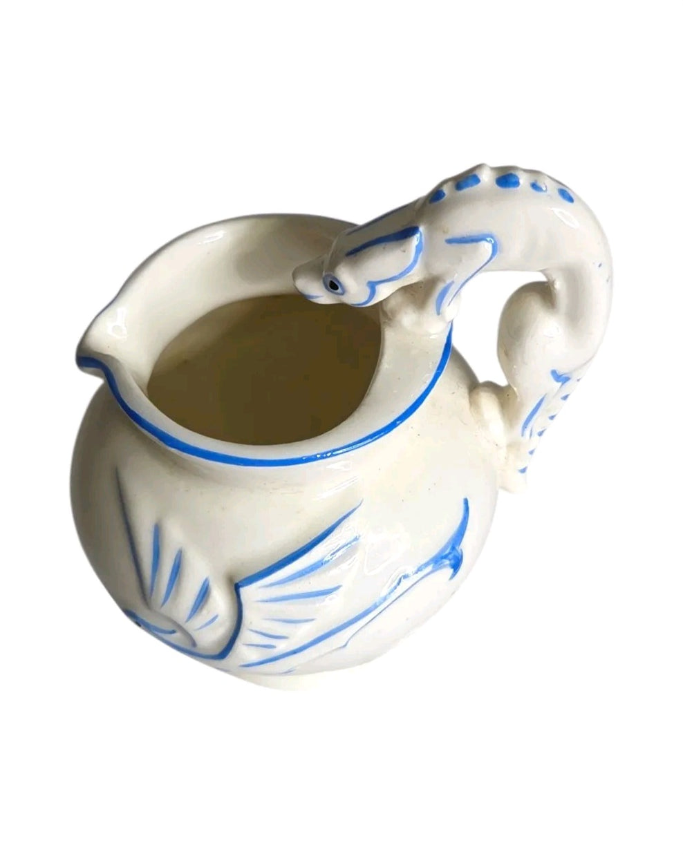 Oddly Darling Vintage ceramic pitcher with off-white glaze, cobalt blue bird motifs, and a sculptural animal handle.