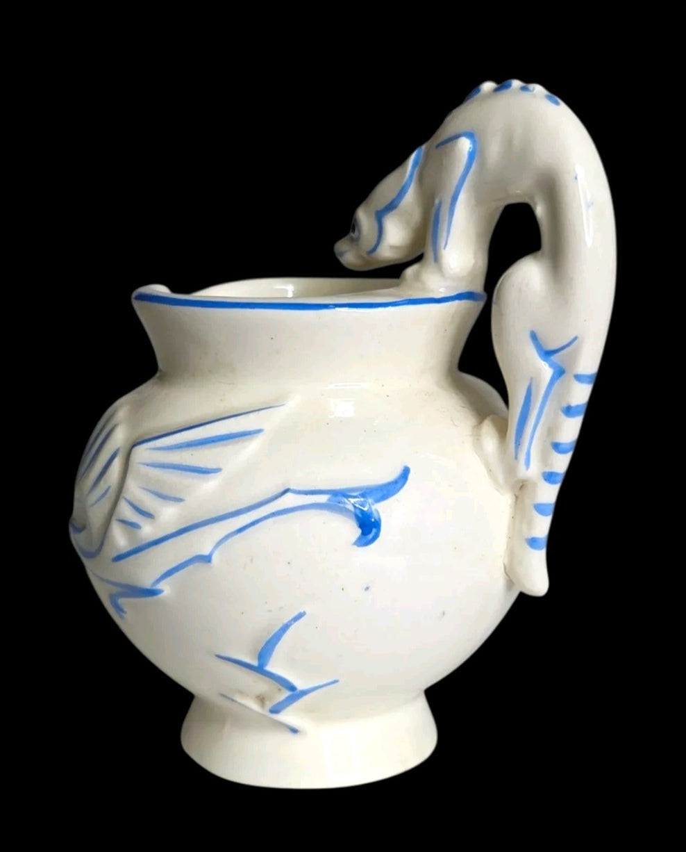 Oddly Darling Vintage ceramic pitcher with off-white glaze, cobalt blue bird motifs, and a sculptural animal handle.