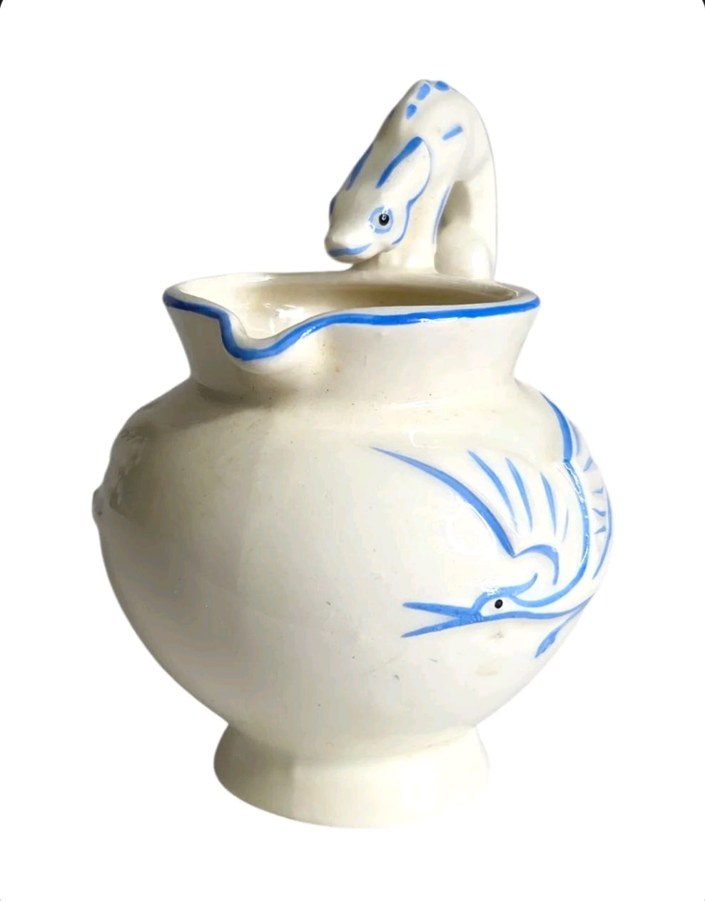 Oddly Darling Vintage ceramic pitcher with off-white glaze, cobalt blue bird motifs, and a sculptural animal handle.