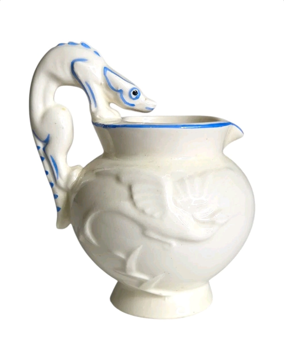 Oddly Darling Vintage ceramic pitcher with off-white glaze, cobalt blue bird motifs, and a sculptural animal handle.