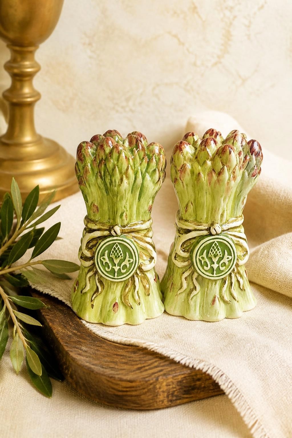 Oddly Darling Vintage ceramic asparagus salt and pepper shakers with hand-painted green details and decorative ribbon.