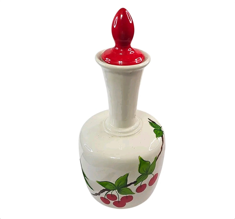 Oddly Darling Vintage hand-painted ceramic decanter with a cream base, cherry motifs, and a glossy red lid.