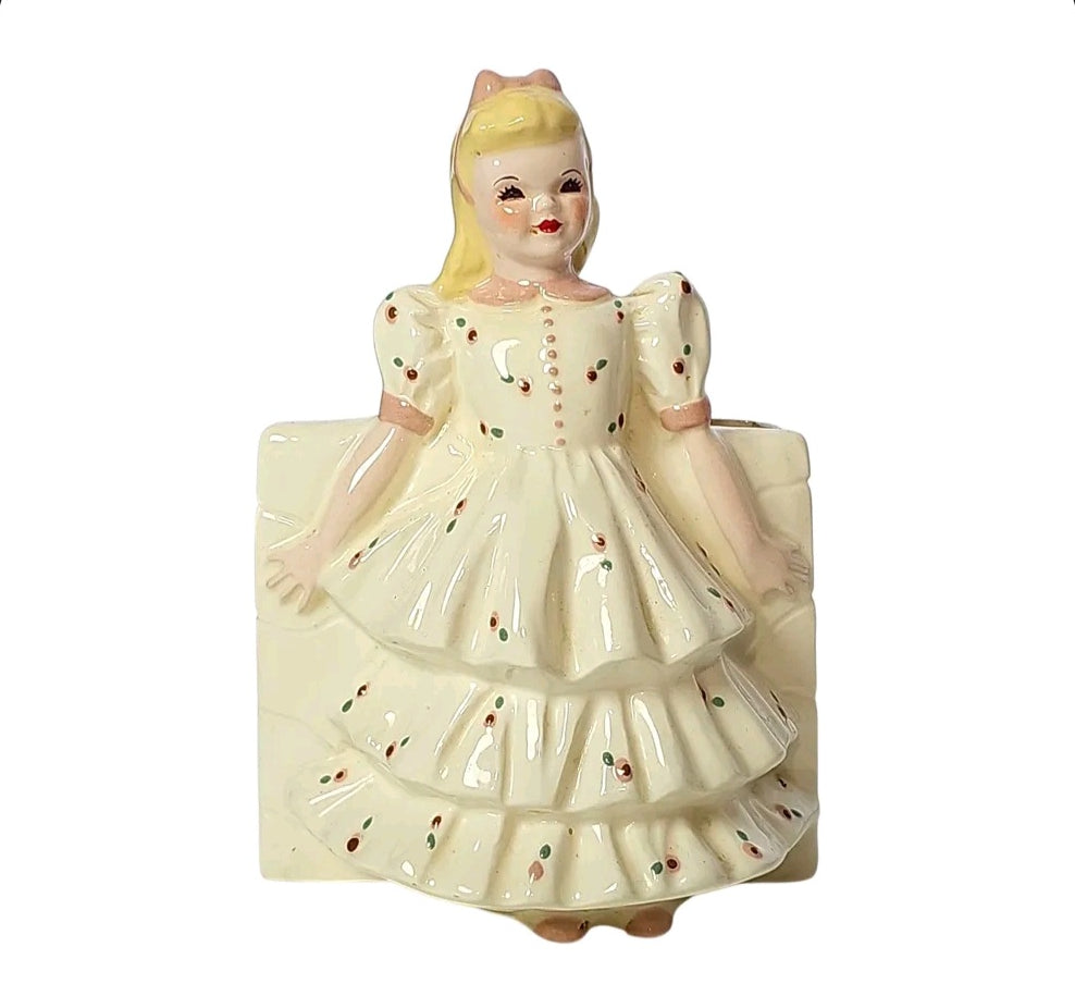 Vintage ceramic girl planter with blonde hair, pink bow and rosebud ruffle dress