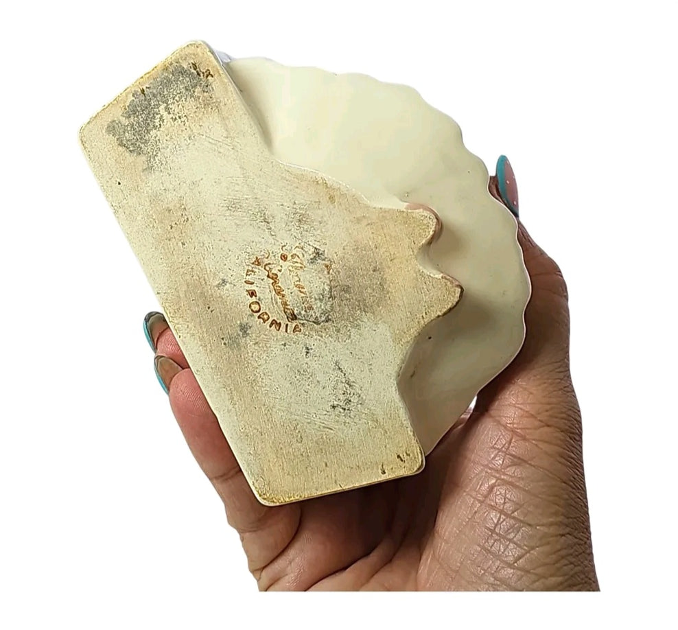 Base of vintage girl planter showing impressed California maker's mark
