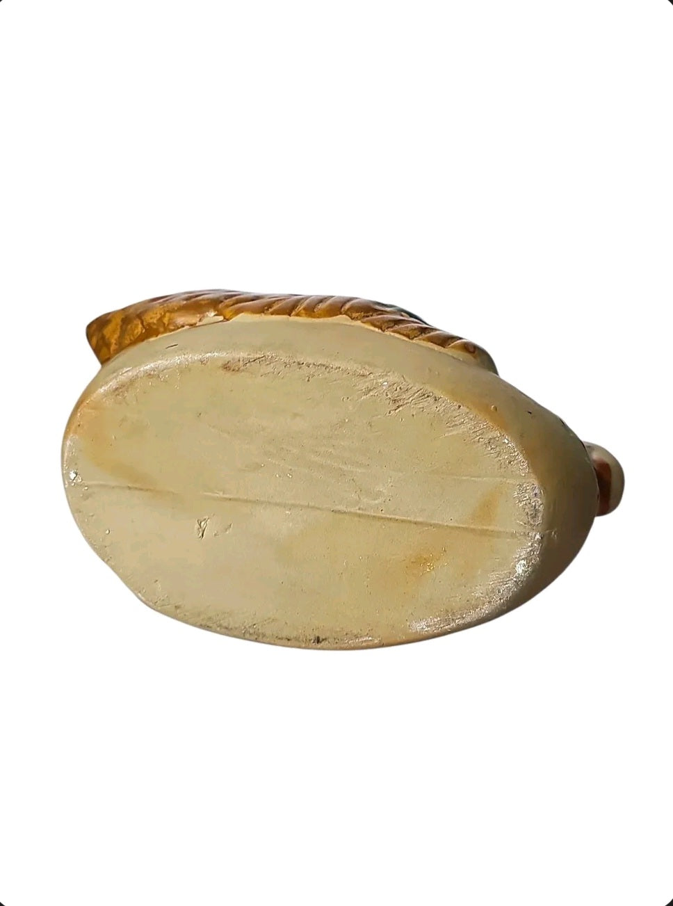 Oddly Darling Vintage ceramic swan planter base showing the flat, neutral-toned bottom and textured wing details.