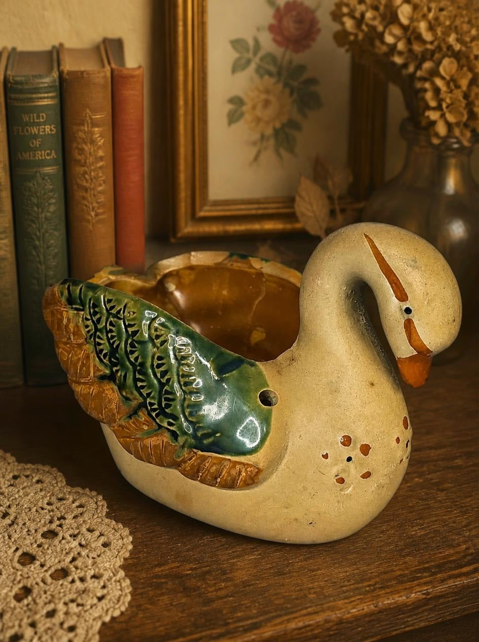 Oddly Darling Vintage ceramic swan planter with green and brown hand-painted wing details on a rustic wooden shelf.