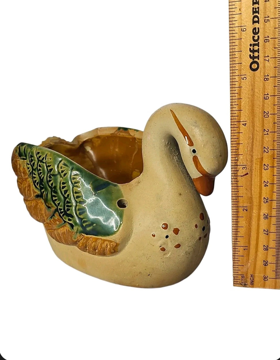 Oddly Darling Vintage ceramic swan planter with green and brown hand-painted wing details and a neutral base.