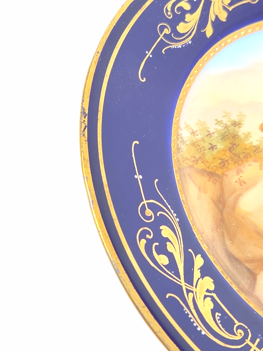 Oddly Darling Vintage porcelain display plate with cobalt blue border, gold-gilt scrollwork, and pastoral scene.