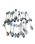 Oddly Darling Vintage collection of assorted souvenir spoons featuring travel landmarks, Disney themes, and enamel details