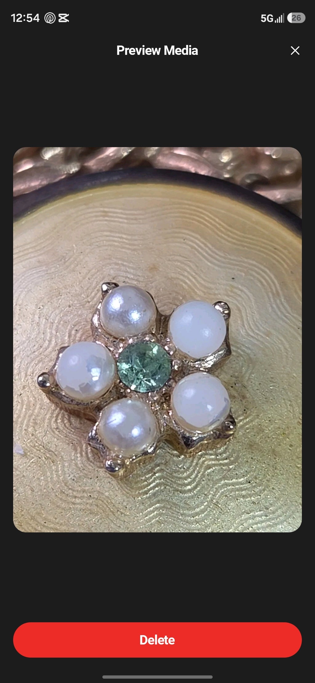Oddly Darling Vintage Coro brooch featuring a floral motif with faux pearls and a green rhinestone on gold guilloche