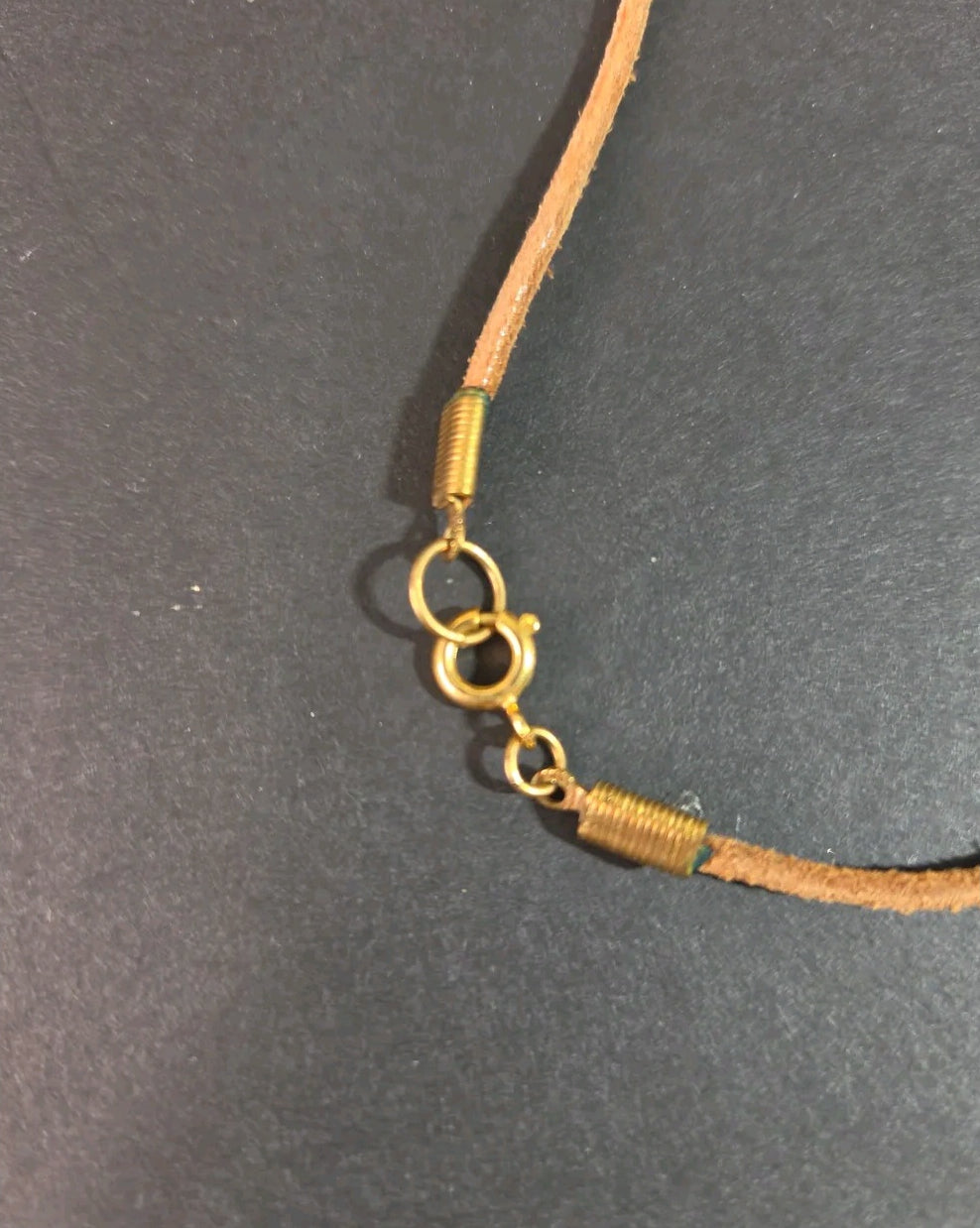 Oddly Darling Vintage crayon necklace featuring a natural leather cord and gold-tone metal spring clasp hardware.