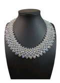 Oddly Darling Vintage handcrafted crystal statement collar necklace with multi-layered faceted clear beads on a display