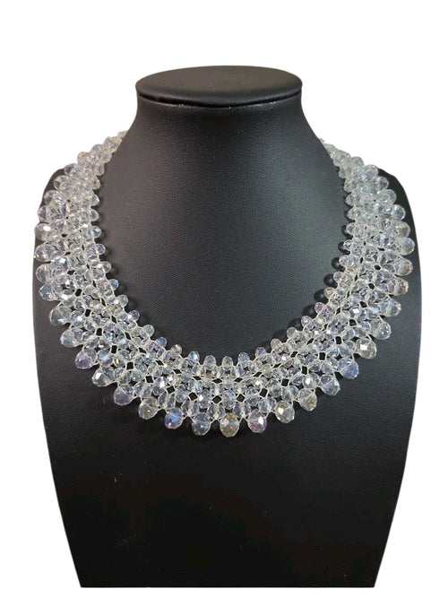 Oddly Darling Vintage handcrafted crystal statement collar necklace with multi-layered faceted clear beads on a display