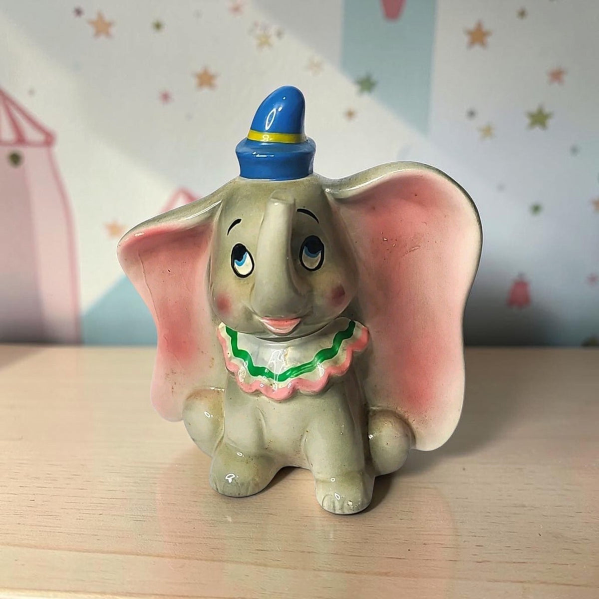 Oddly Darling Vintage ceramic Dumbo figurine featuring a blue hat and ruffled collar, classic Disney collectible.