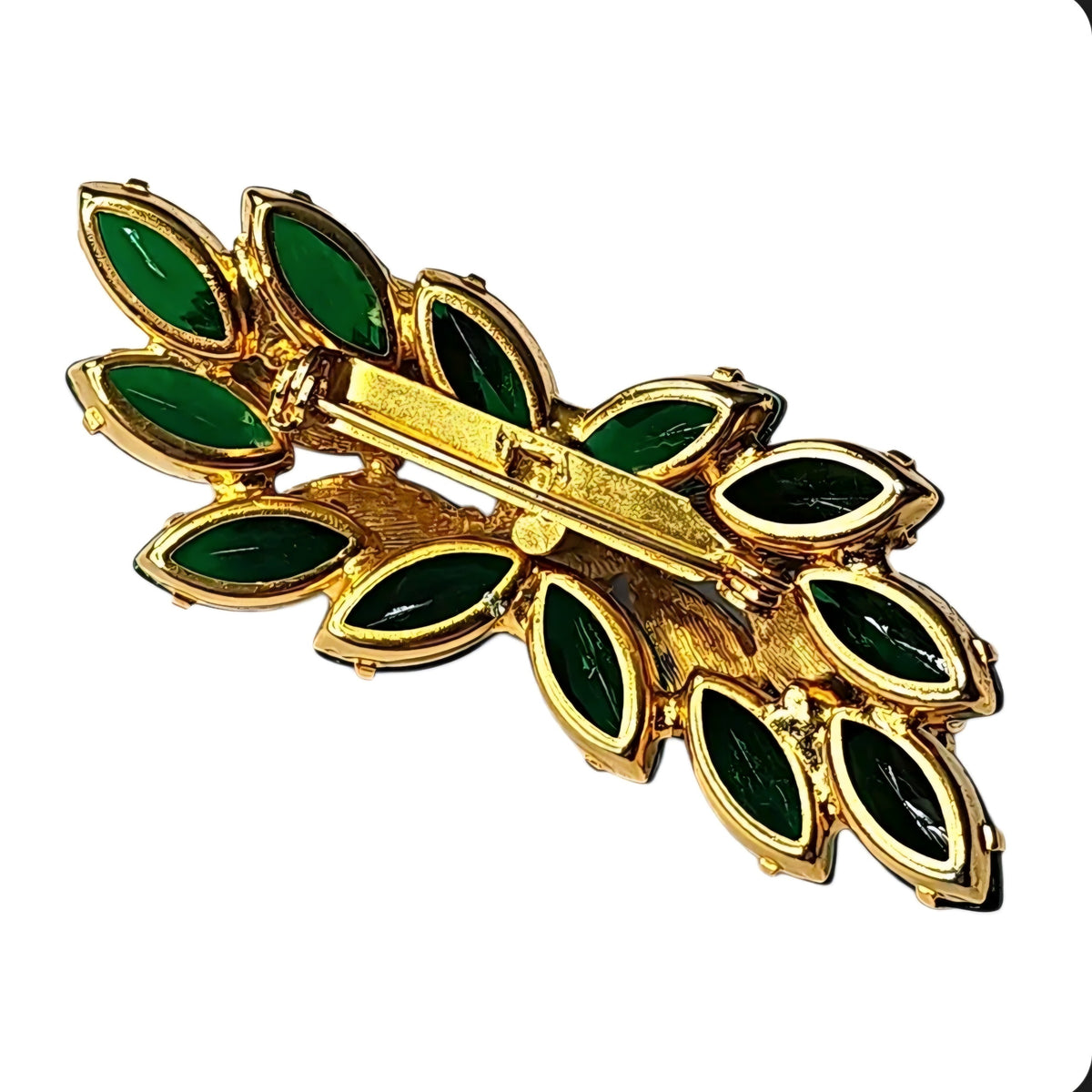 Oddly Darling Vintage gold-tone brooch featuring emerald green marquise-cut stones in a botanical leaf design.