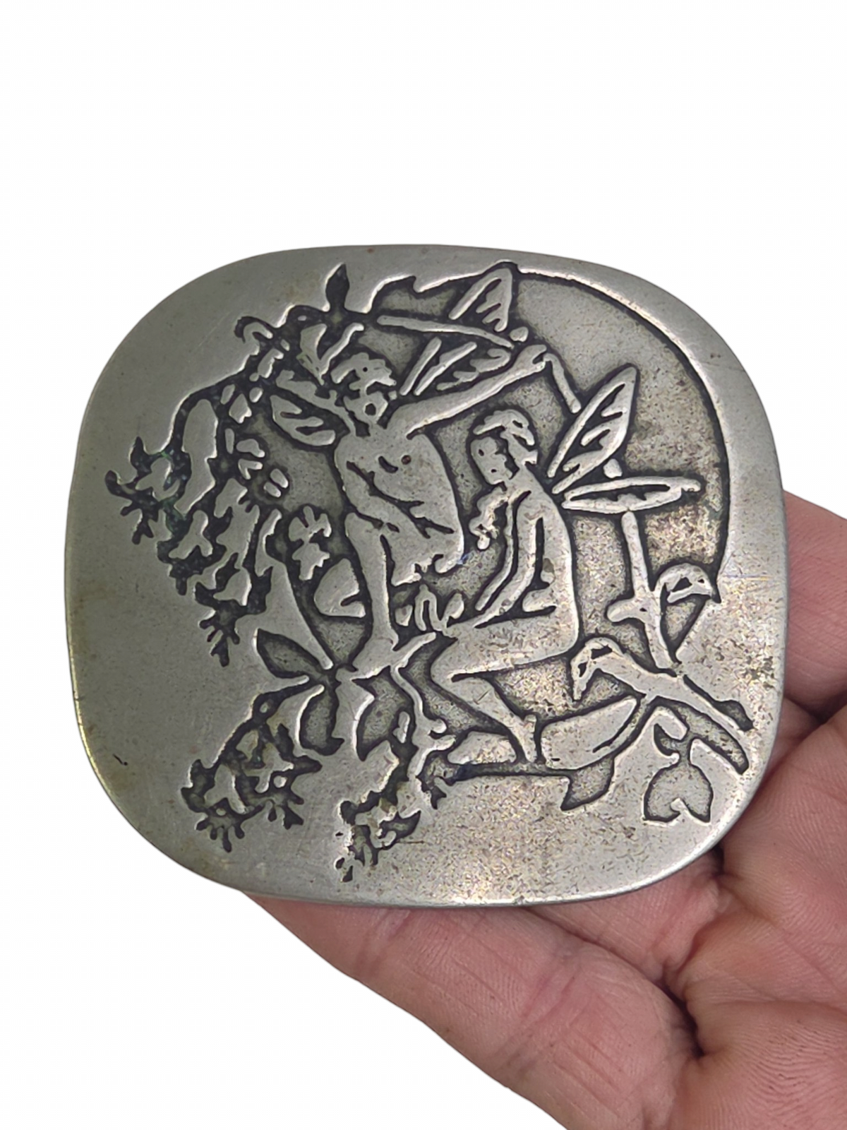 Oddly Darling Vintage silver-toned belt buckle featuring an embossed fairy and foliage design in a weathered finish.