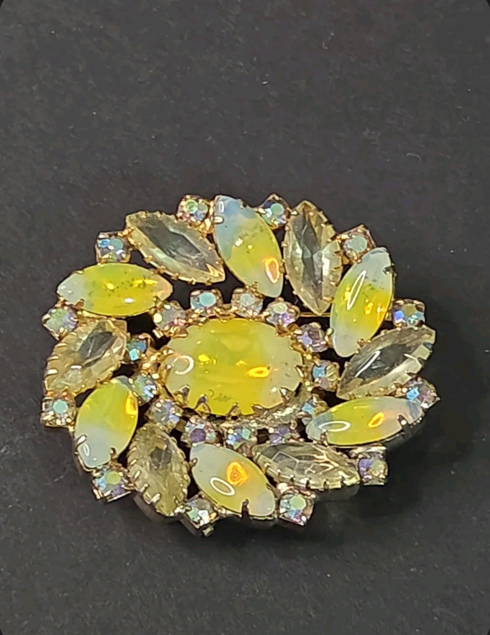 Oddly Darling Vintage floral brooch with a central oval cabochon, marquise-cut iridescent stones, and gold-tone base.