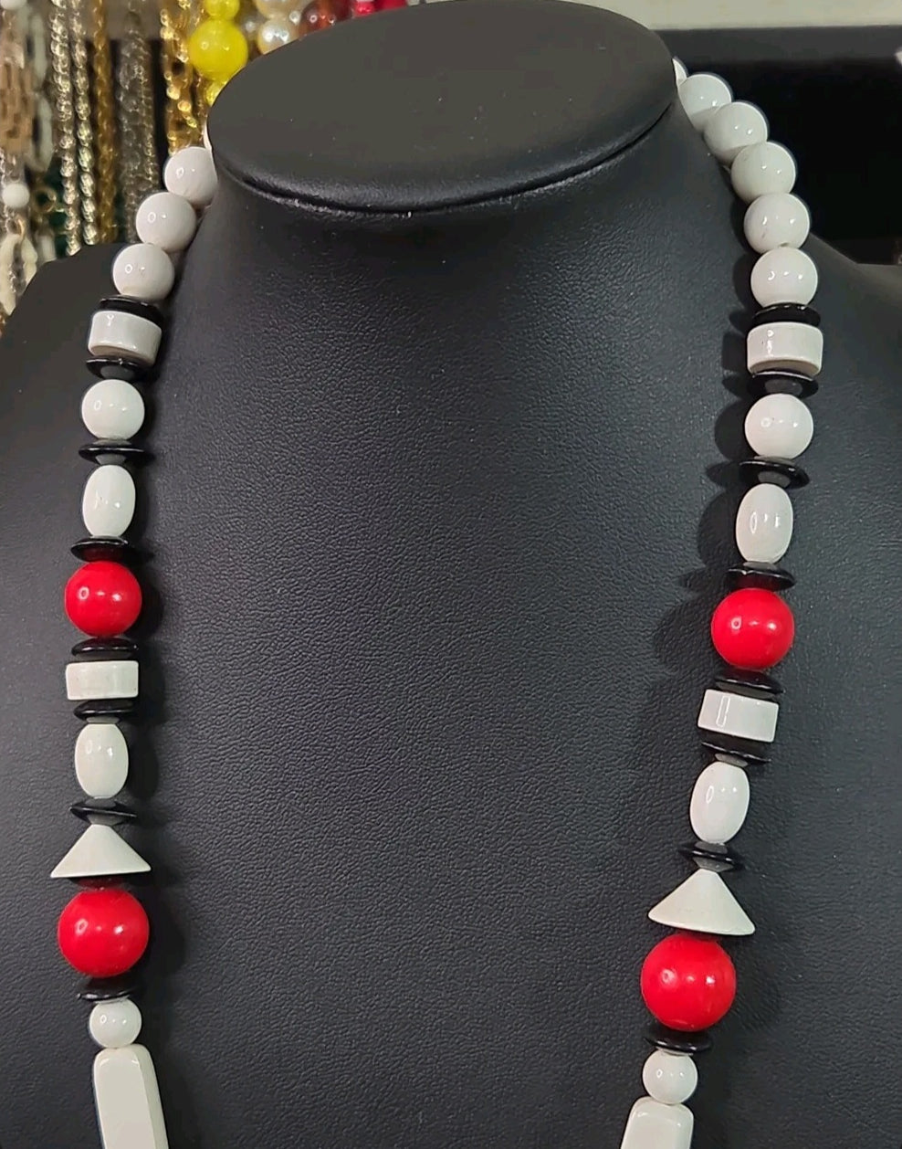 Oddly Darling Vintage geometric statement necklace featuring red, white, and black beads in various architectural shapes.