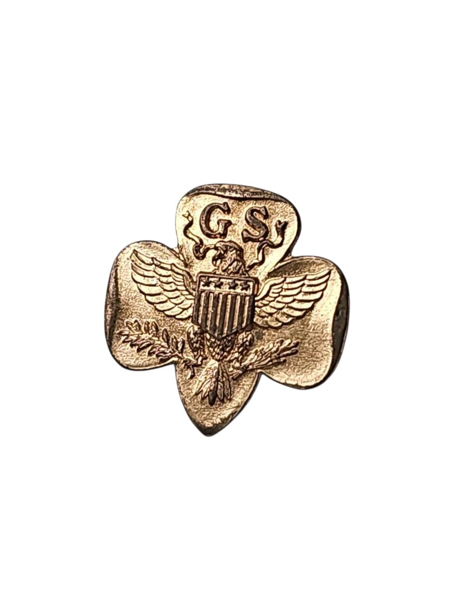 Oddly Darling Vintage gold-tone Girl Scouts trefoil pin featuring an eagle and shield emblem on a white background.