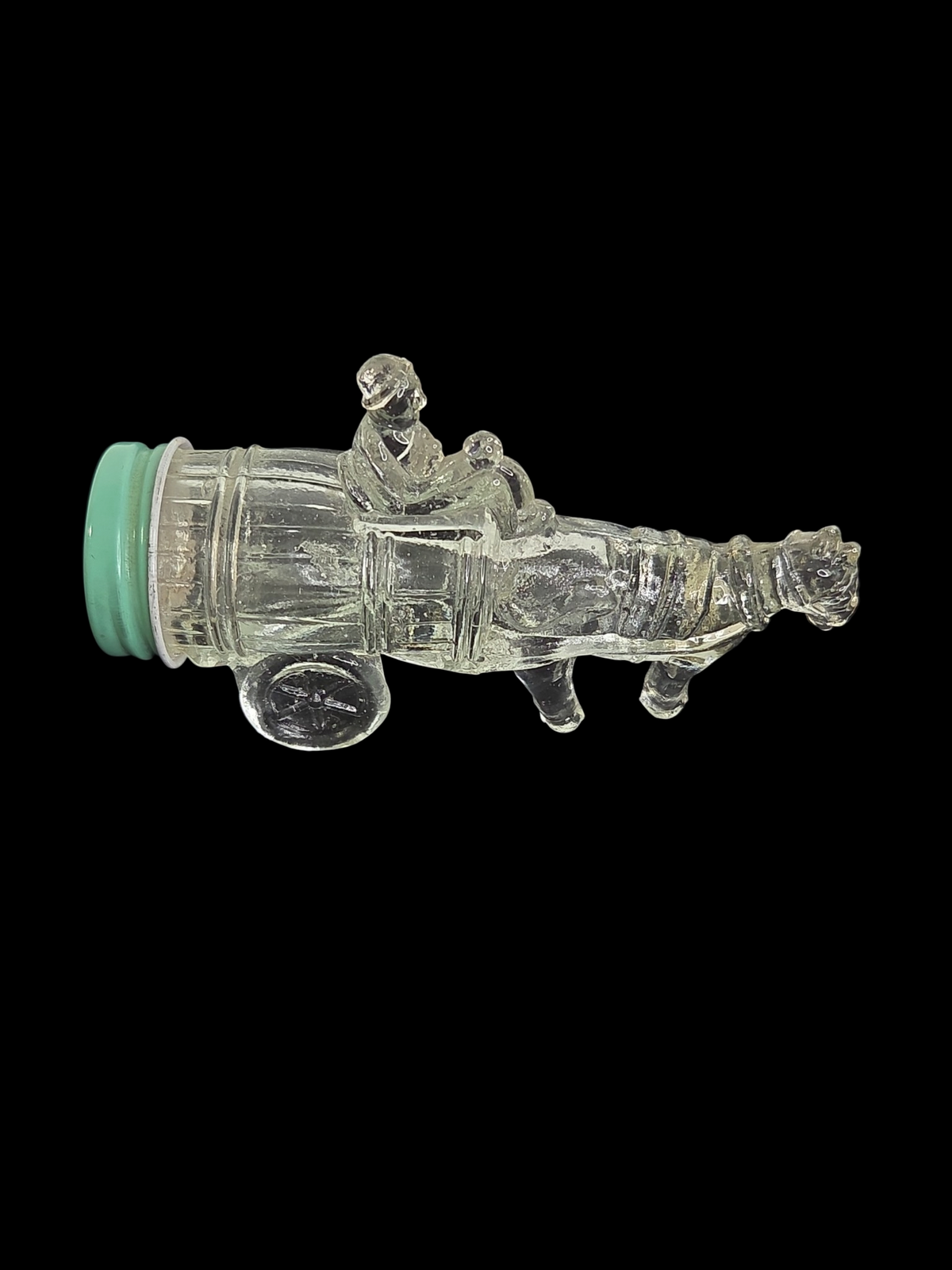 Oddly Darling Vintage clear glass bottle shaped like a horse-drawn cart with a light green screw-top lid.
