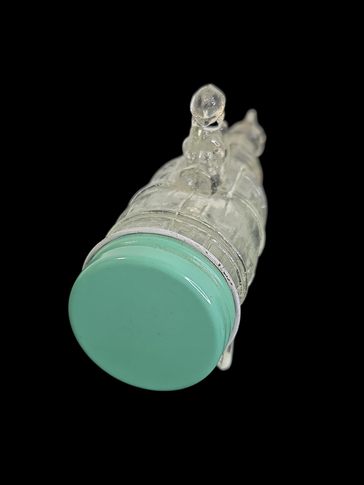 Oddly Darling Vintage clear glass horse and cart decorative bottle with a light green screw-top lid on black background