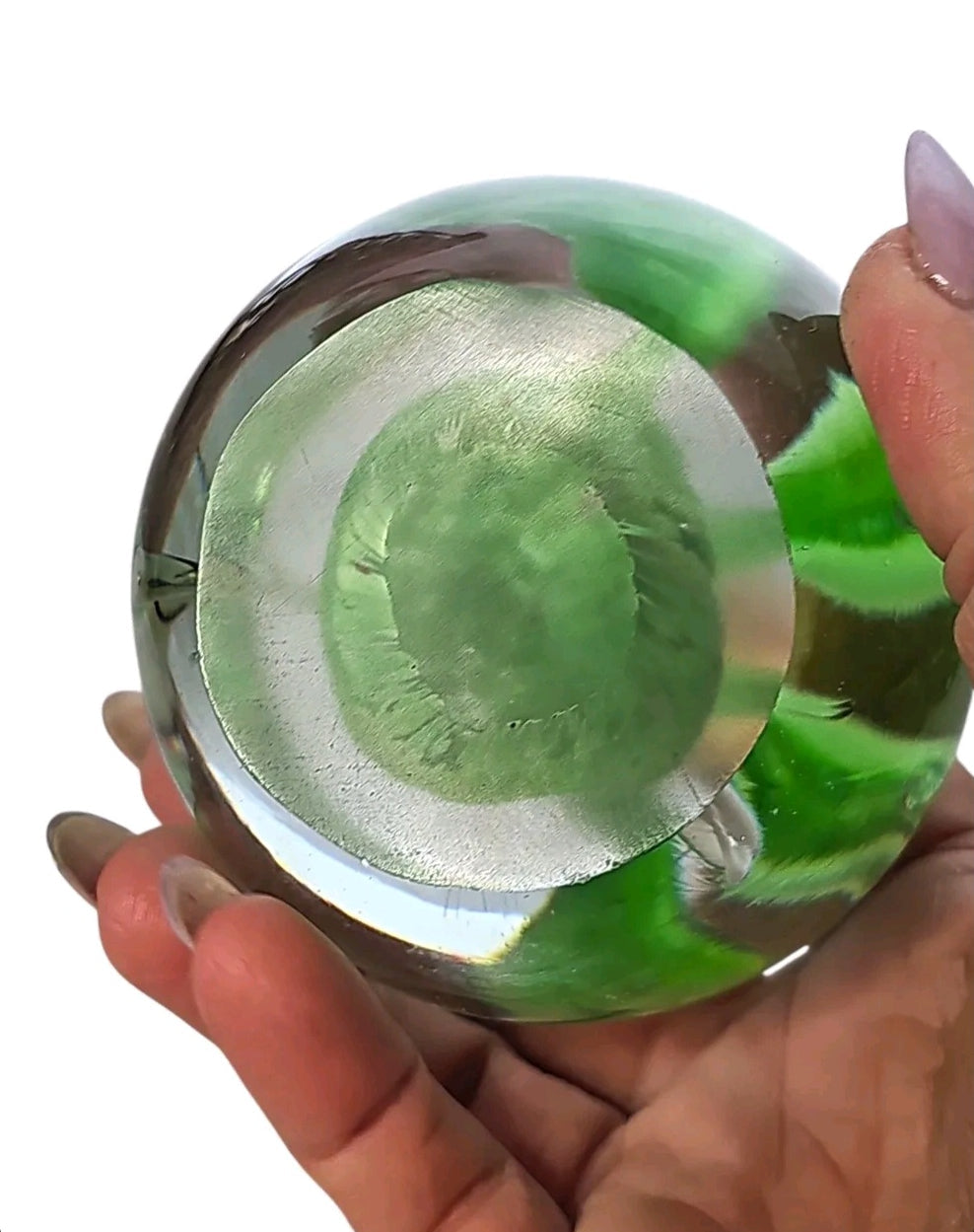 Oddly Darling Vintage glass paperweight base showing green bamboo forest design held in a hand