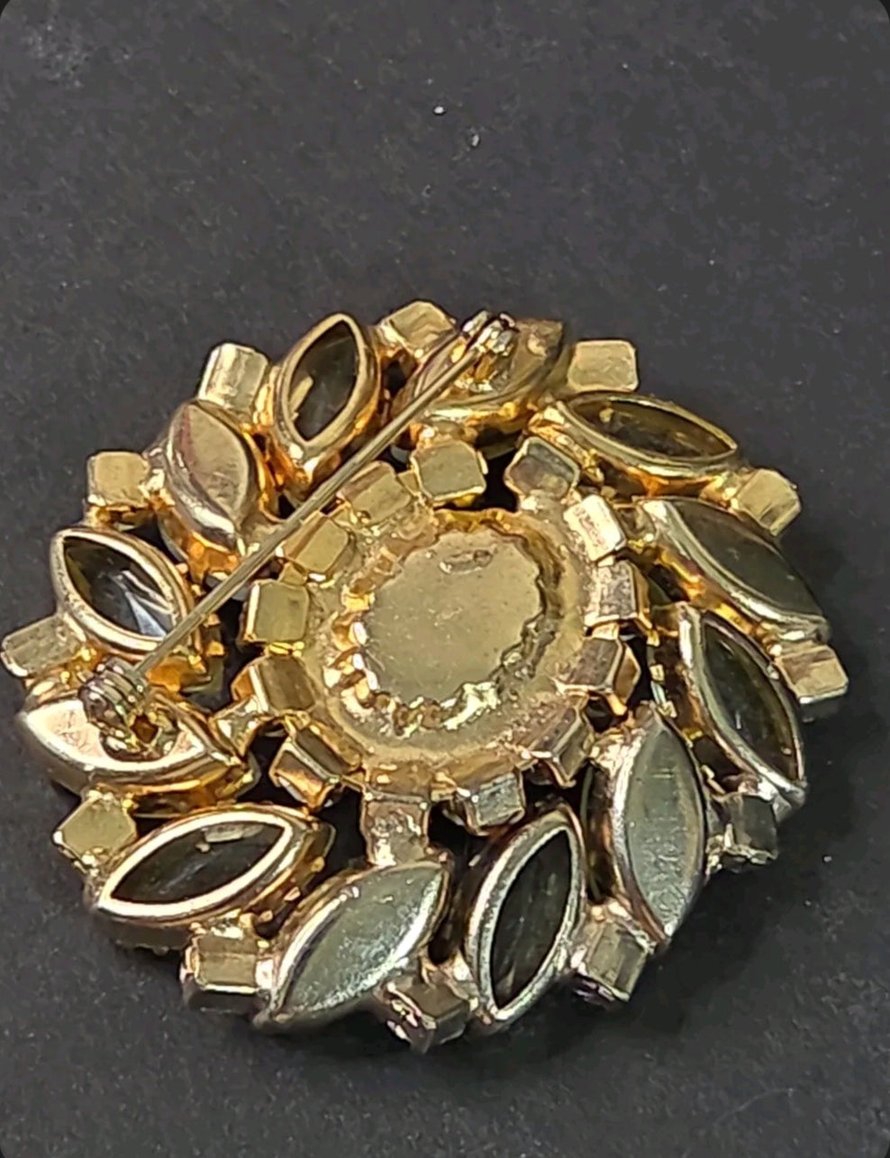 Back view of an Oddly Darling Vintage gold-tone floral brooch featuring a secure pin-back closure and marquise stones.