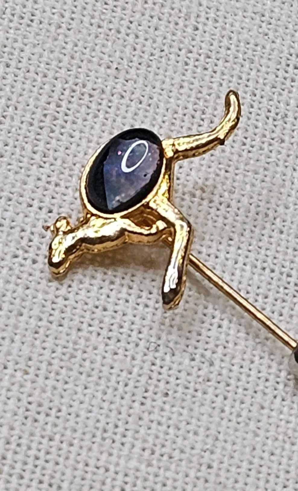 Oddly Darling Vintage gold-tone kangaroo lapel pin featuring a dark cabochon stone on a textured white background.