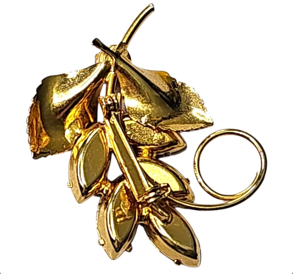 Oddly Darling Vintage gold-tone leaf brooch with ruby-red marquise crystals and elegant swirl detail.