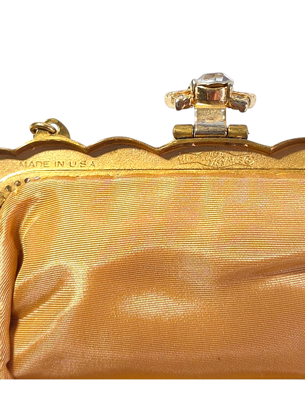 Inside frame of the Whiting & Davis bag stamped Made in U.S.A., with the clasp hinge and gold satin lining