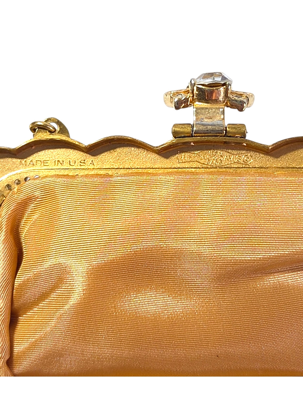 Inside frame of the Whiting & Davis bag stamped Made in U.S.A., with the clasp hinge and gold satin lining