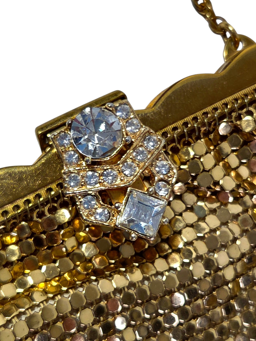 Angled close-up of the rhinestone clasp and scalloped gold-tone frame where the mesh hangs from it