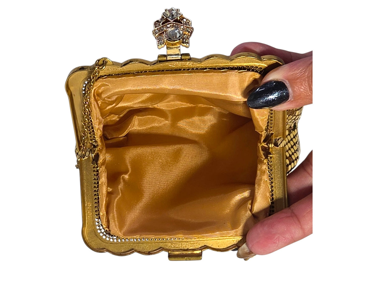 Whiting & Davis mesh bag held open, showing the gold satin lining that appears unused