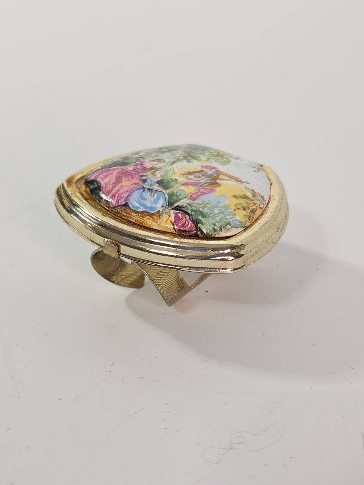 Oddly Darling Vintage gold-tone ring with a hinged lid featuring a colorful pastoral garden scene and internal mirror.