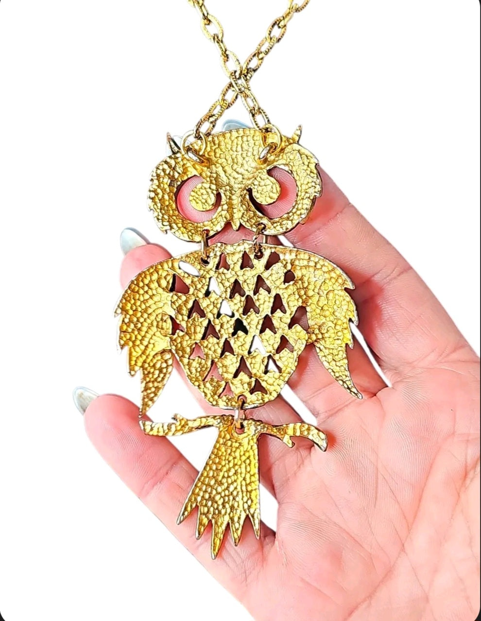 Oddly Darling Vintage gold-tone owl pendant necklace with intricate textured feather details held in a hand