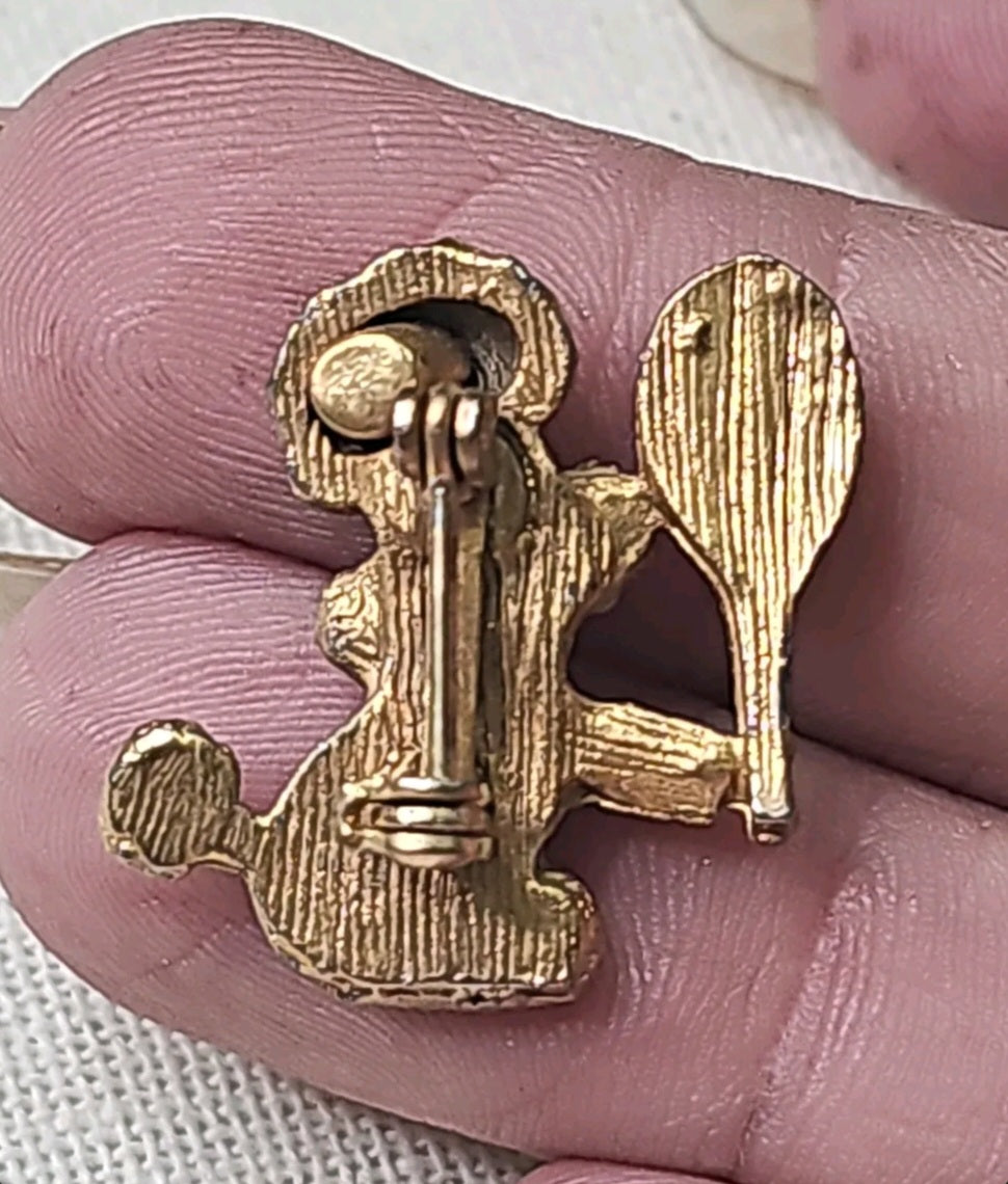 Oddly Darling Vintage gold-tone tennis poodle brooch pin showing the textured metal back and secure pin closure