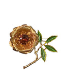 Oddly Darling Vintage gold-tone rose brooch with a deep amber center stone and hand-enameled green leaves.