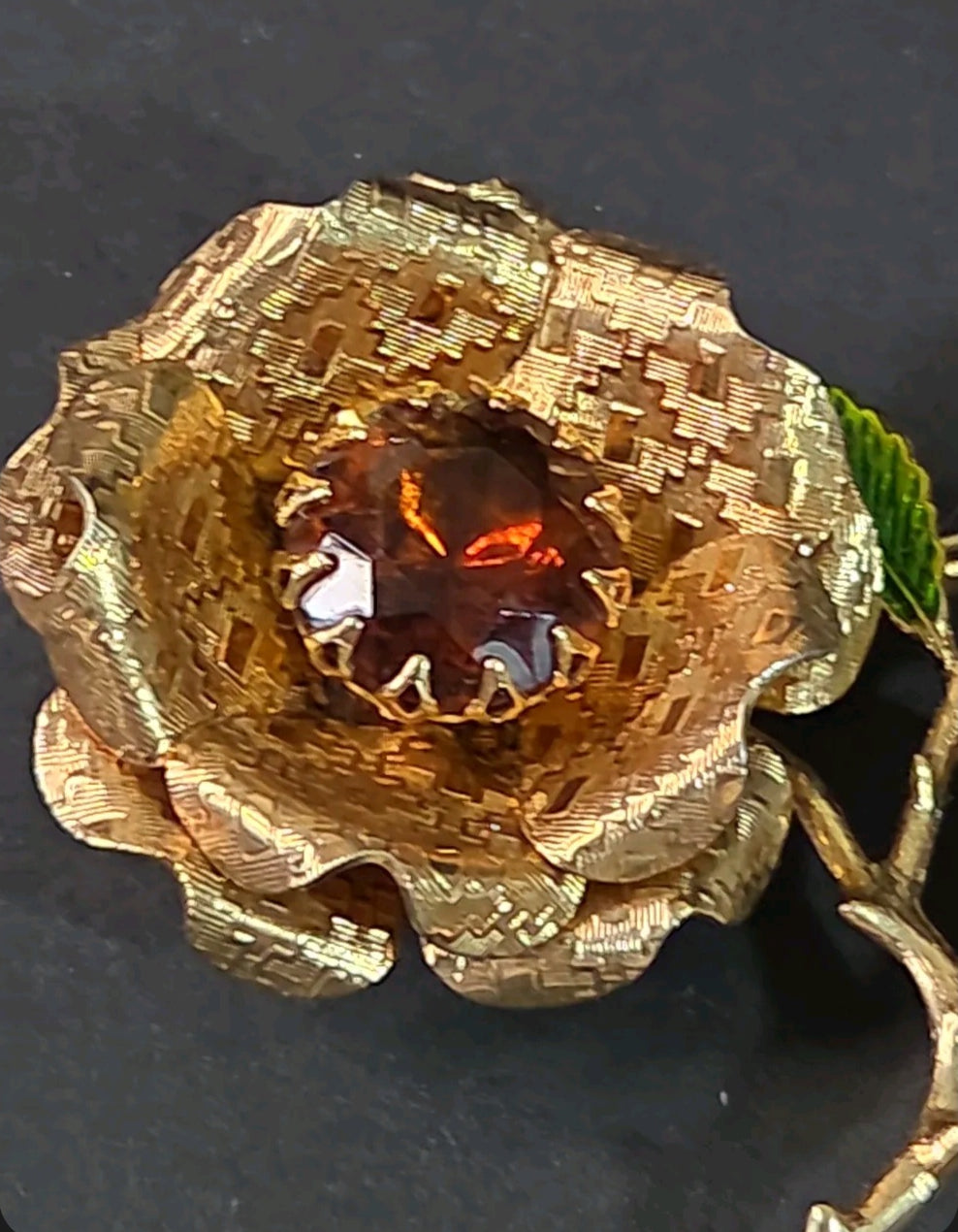Oddly Darling Vintage gold-tone rose brooch with a faceted amber center stone and green enameled leaf detail.