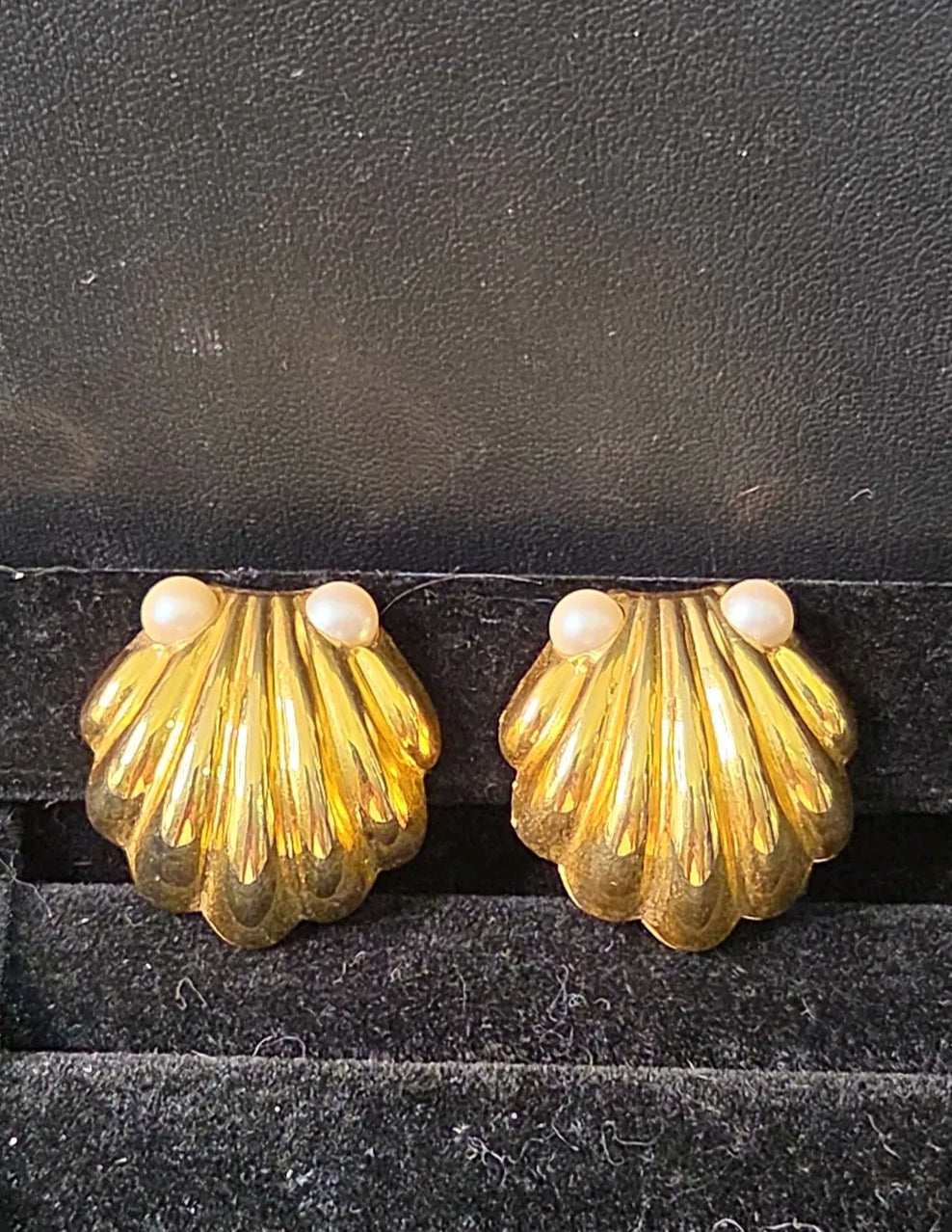 Oddly Darling Vintage gold-tone scalloped shell clip-on earrings with faux pearl accents on a black velvet display.