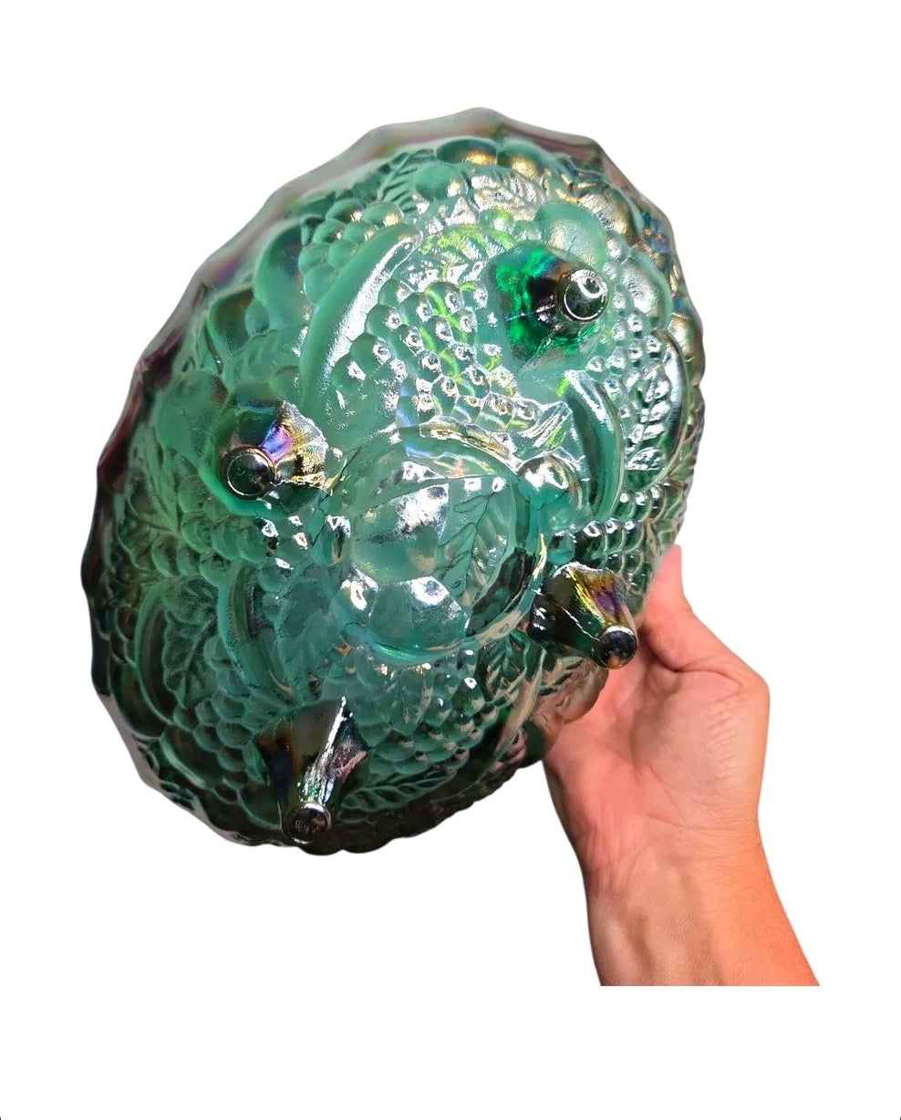Oddly Darling Vintage iridescent green carnival glass bowl with embossed grape and vine motif and three sturdy feet.