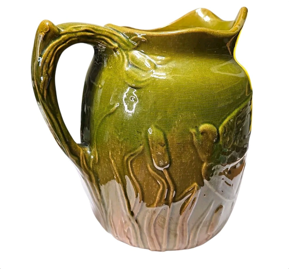Majolica style pitcher with bird relief and twig handle