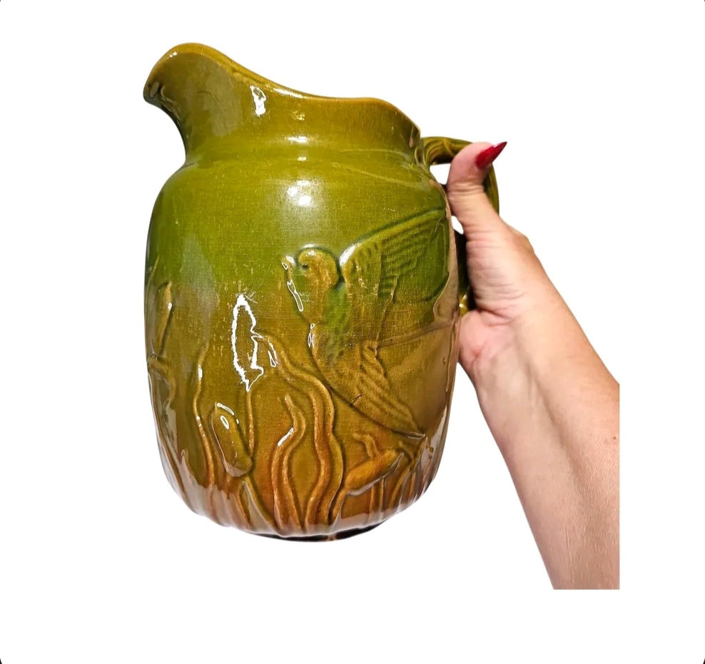 Majolica style pitcher with bird relief and twig handle