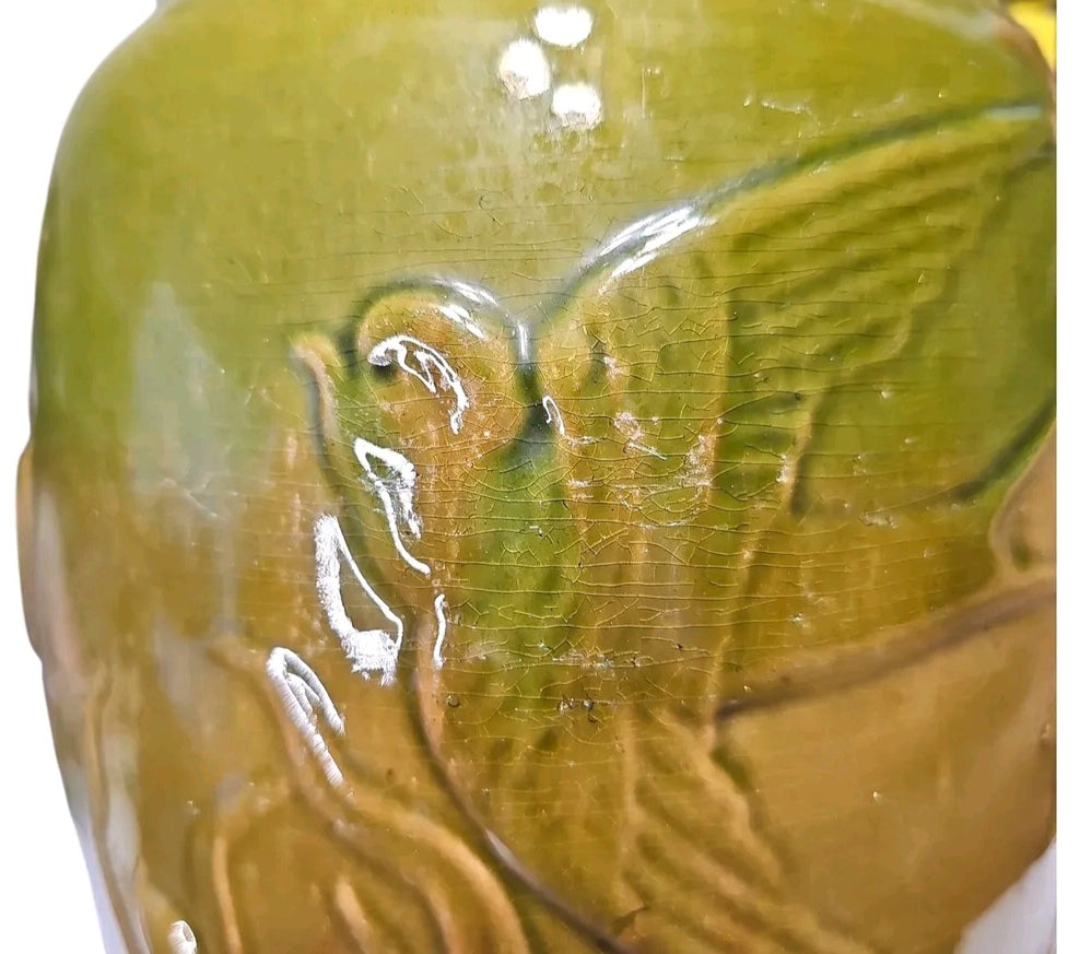 Majolica style pitcher with raised bird and reed design