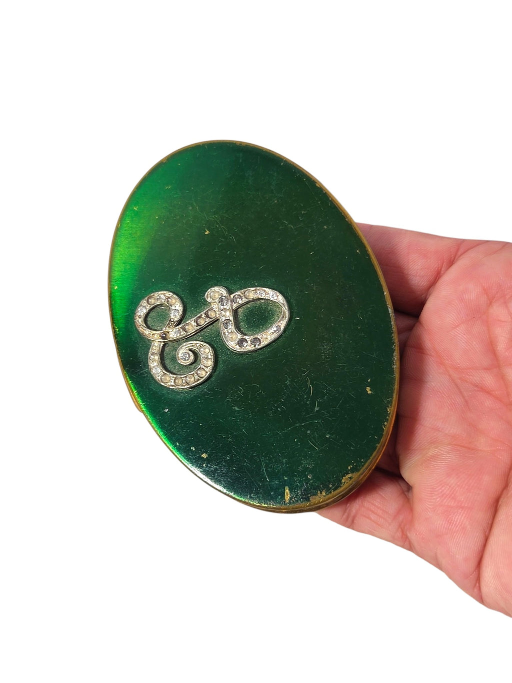 Vintage oval compact with green enameled lid and rhinestone script initial L, scratches and edge wear visible