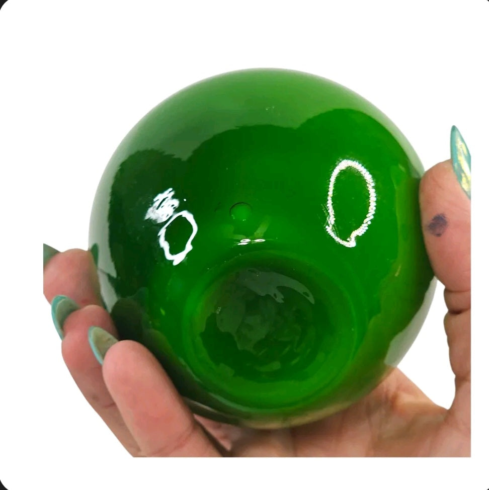Oddly Darling Vintage hand blown deep green glass apple paperweight with a polished high-gloss finish held in hand