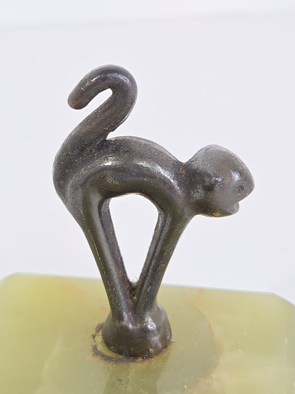 Oddly Darling Vintage green onyx trinket tray featuring a dark metal cat figurine in an arching pose