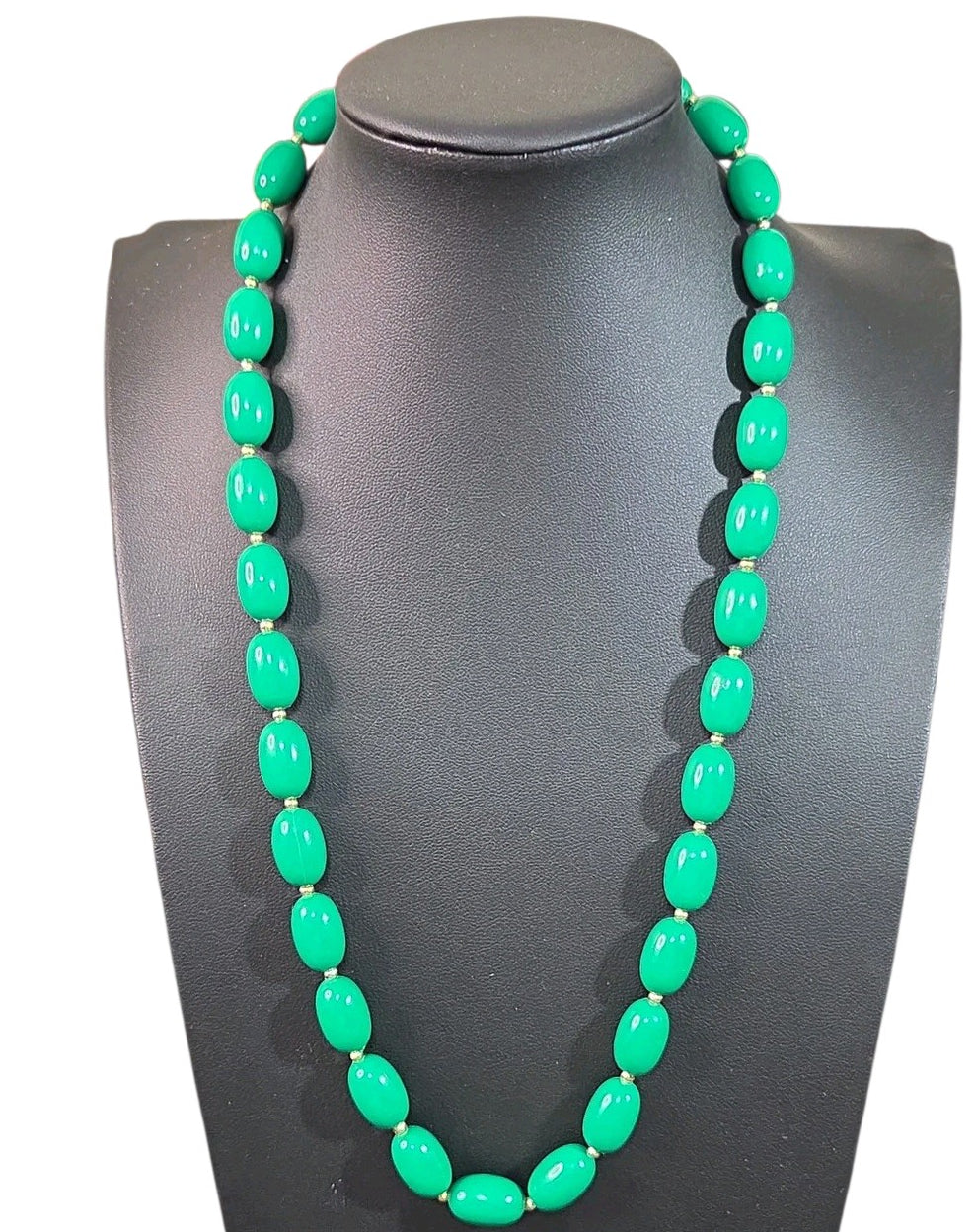 Oddly Darling Vintage emerald green oval bead necklace with small gold-tone spacers on a black display bust.